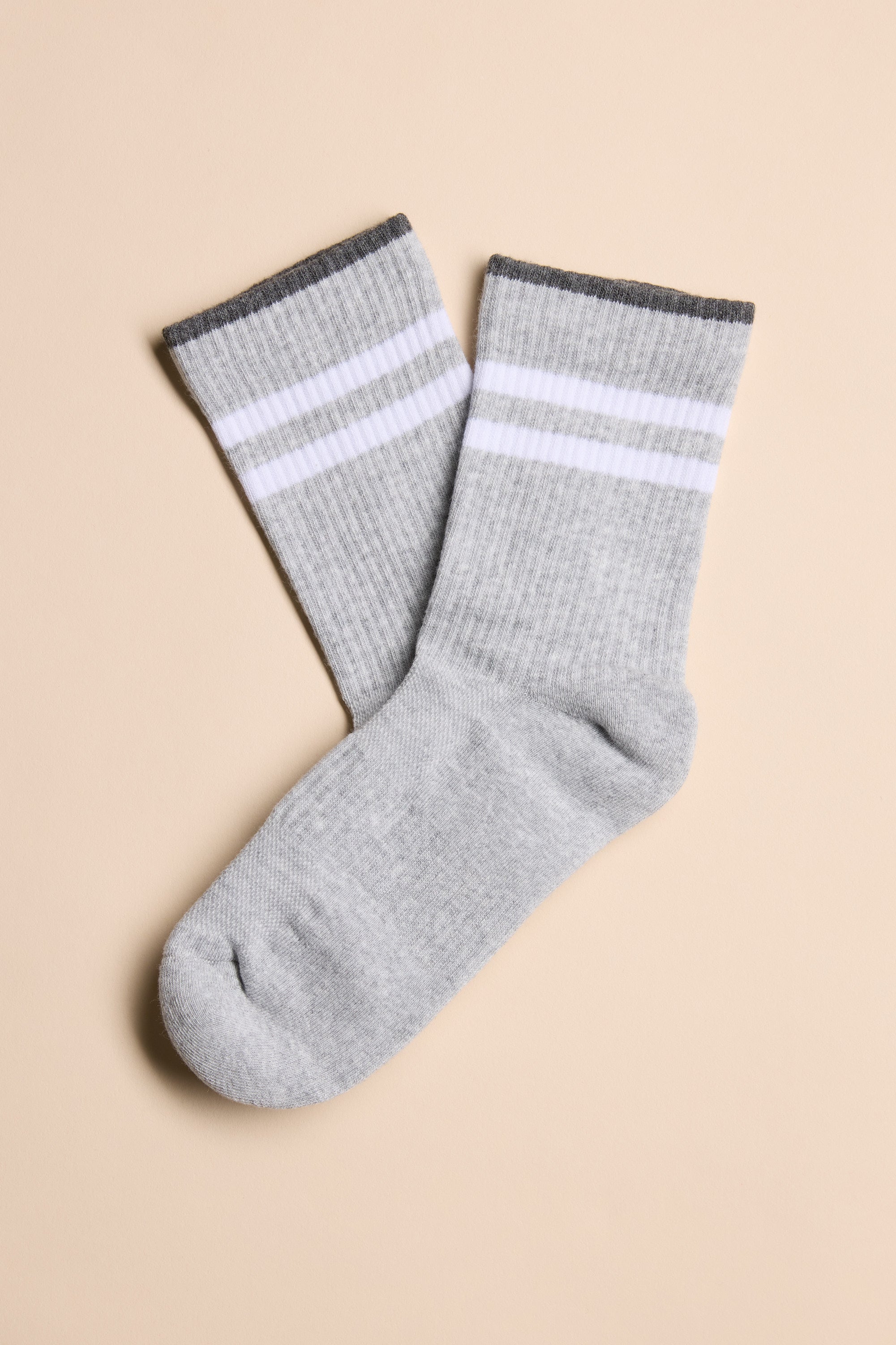 A pair of gray Barkers Emerson Sport Socks with two white stripes and a dark gray cuff, shown flat on a beige surface—perfect crew socks for the gym or daily wear.