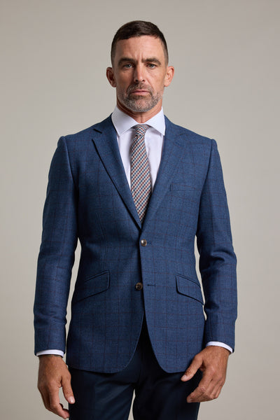 A man with short brown hair and a trimmed beard wears the Barkers Findlay Check Blazer over a white dress shirt and patterned tie, standing against a plain light background, looking directly at the camera.