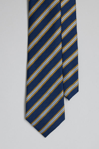 The Barkers Milton Stripe Tie is a blue silk tie with diagonal gold and light blue stripes and classic jacquard prints, shown on a plain light gray background.