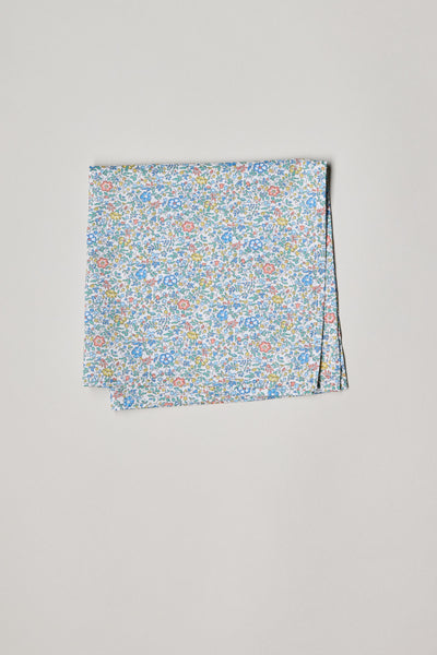 The Katie and Millie Liberty PS by Liberty is a folded Tana Lawn cotton pocket square featuring a small, colorful floral print with blue, pink, and green flowers on a white background, displayed on a plain light surface.