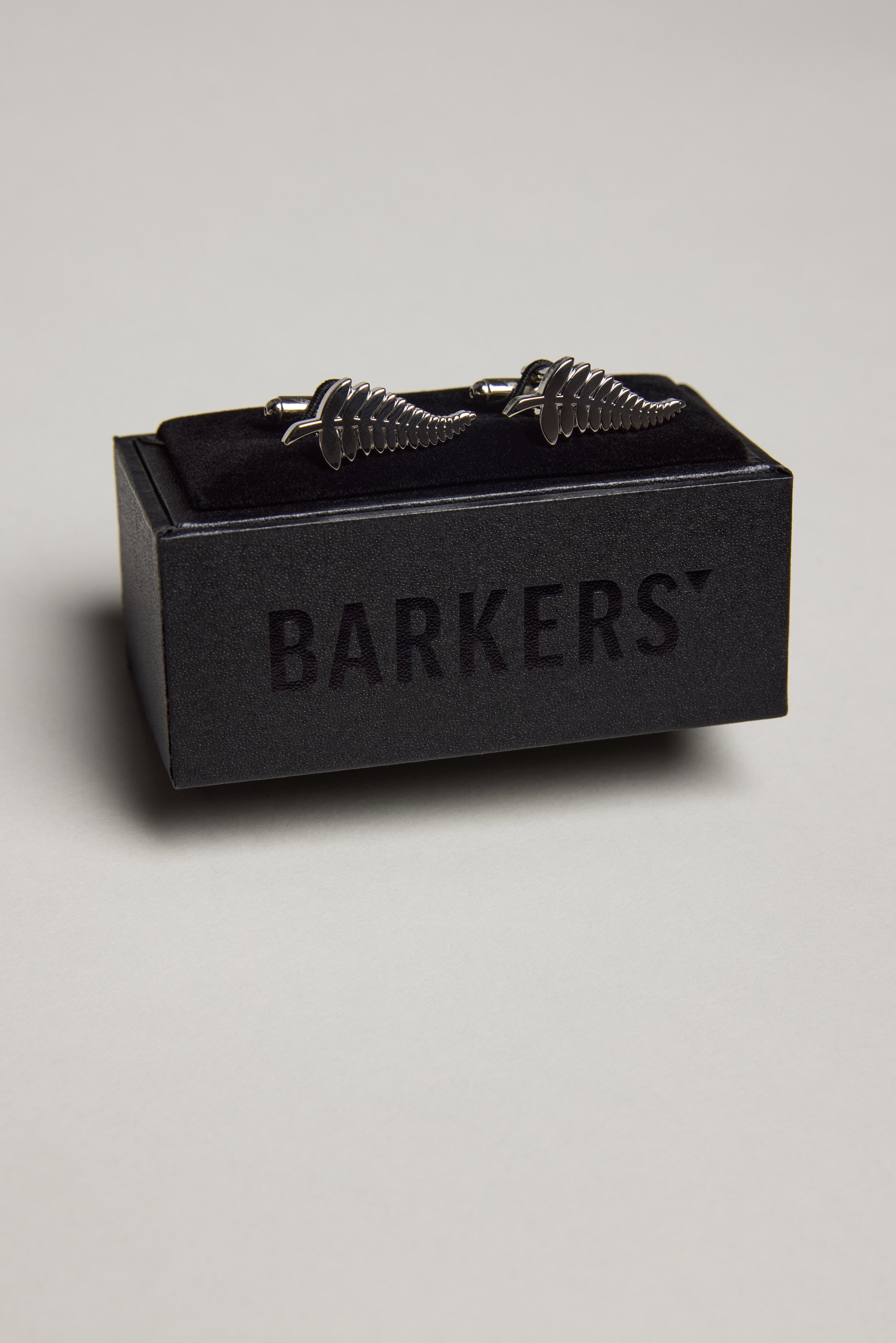 The Barkers Classic Silver Fern Cufflinks have a polished finish and come displayed on a black velvet stand with a branded box—ideal for French cuff shirts.