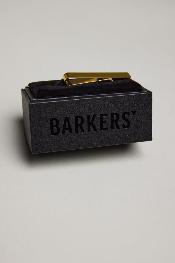 The Hero Tie Clip by Barkers rests on black velvet in a sleek box boldly marked "BARKERS," making it the perfect accessory to add timeless style to any formal occasion.