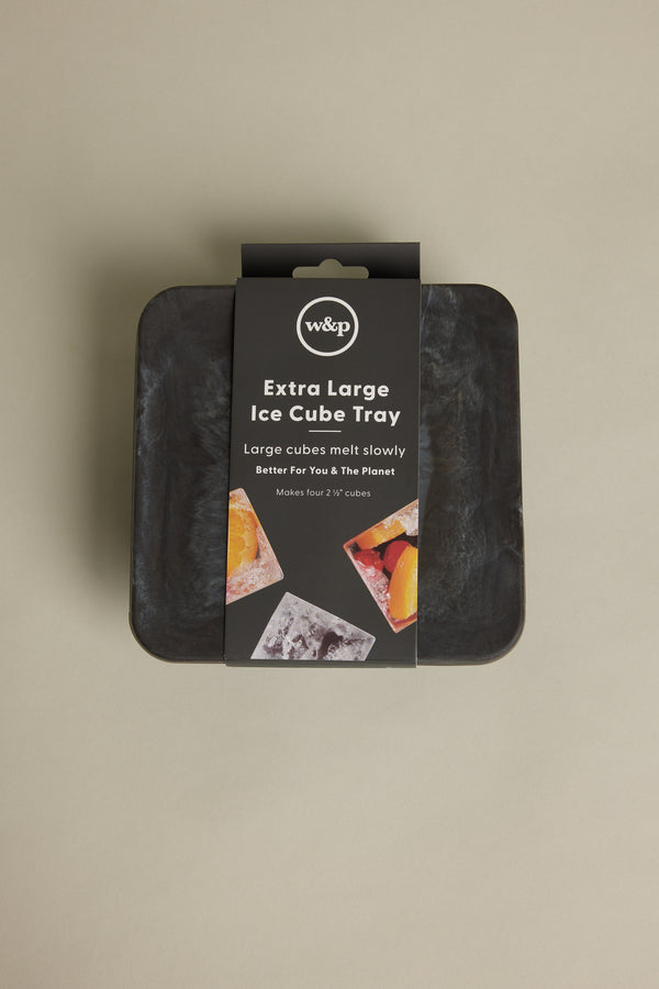 An Ice Tray Sphere Marble Black by Other is shown in its packaging against a beige background. Ideal for your home bar, the label highlights slow-melting ice spheres and features images of drinks with ice and fruit.