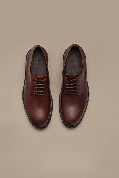 A pair of Saville Derby Shoes by Barkers is displayed side by side on a light beige background, highlighting quality Portuguese craftsmanship and timeless men's style.