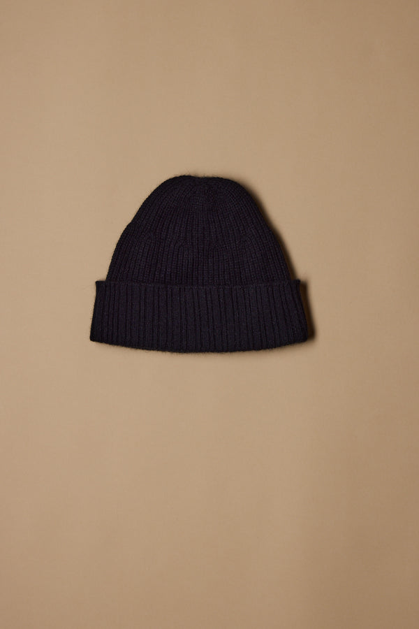 The NZ Made Perino Beanie by Woolyarns Perino, crafted from luxurious merino possum silk with a folded brim, is displayed centered on a plain beige background.