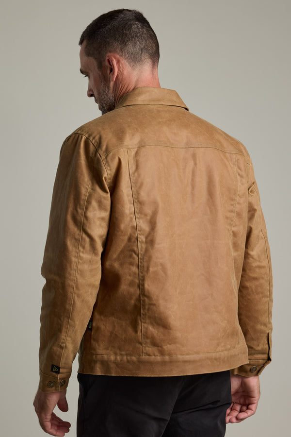 A man in a Barkers Benson Waxed Cotton Sherpa Jacket, shown from the back, plain background.