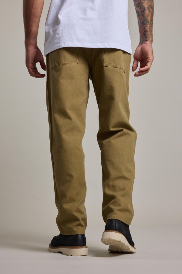 A person is shown from behind, wearing Barkers' Midwood Fatique Pant, black shoes, and a white shirt against a plain light background. A tattooed arm is partially visible.