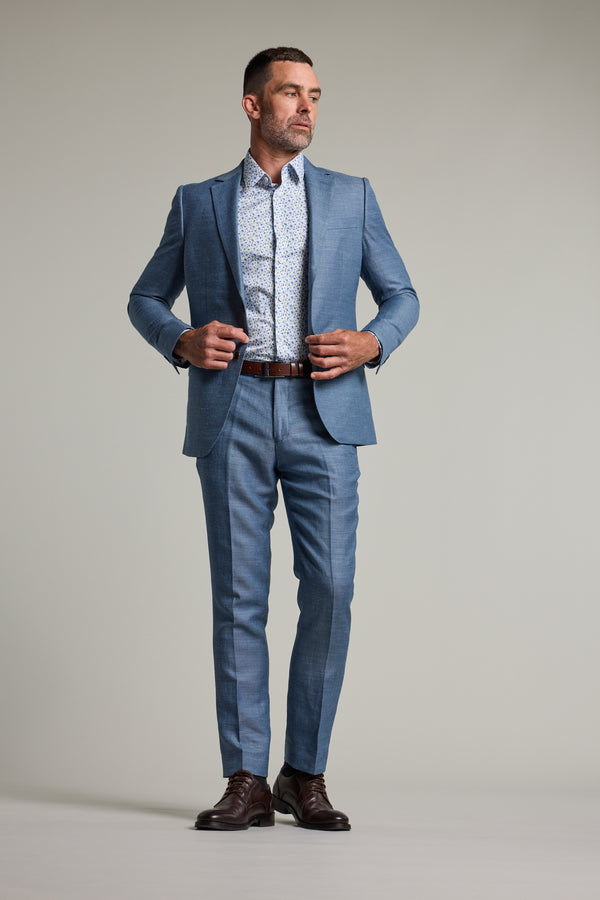 Man in Barkers Garcia Linen Suit Trouser, patterned shirt, brown belt, dark brown shoes.