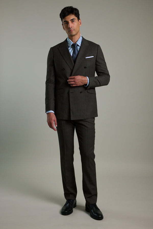 Man wears Barkers Radcliffe Stripe Double Breasted Suit Jacket, blue shirt, and tie.