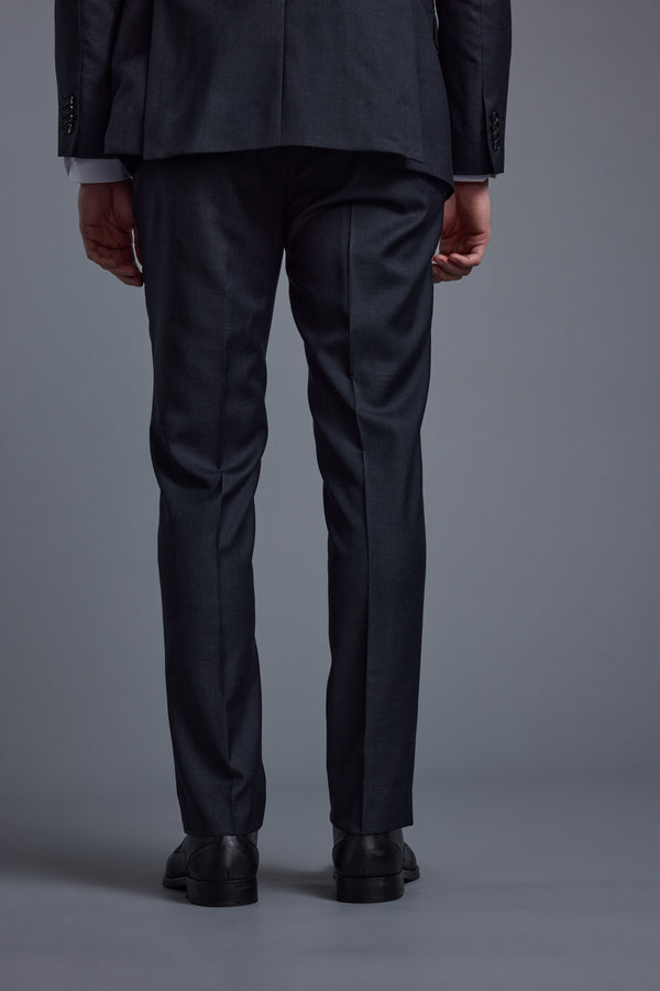 A person wearing Barkers' Mayfair ZQrx Suit Trouser and black shoes stands with their back to the camera against a plain gray background.