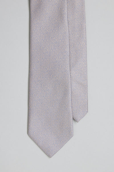 A close-up of the Barkers Empire Texture Tie, a light silk accessory featuring a subtle blue dot jacquard on a pale background—ideal for elevating business attire, shown against a neutral surface.