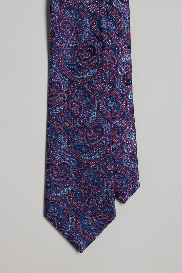 The Barkers Stanton Paisley Tie showcases a detailed blue and red paisley pattern on a dark background, ideal for pairing with silk accessories or matching pocket squares.