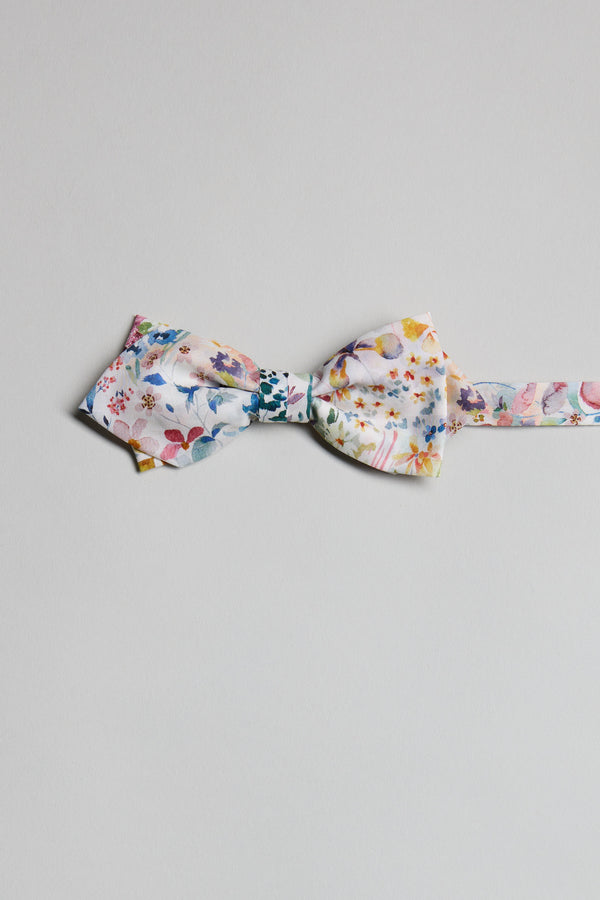 The Liberty Felda Bow Tie by Liberty, handmade in New Zealand from Tana Lawn cotton with a vibrant floral design, is shown laid flat on a light gray background.