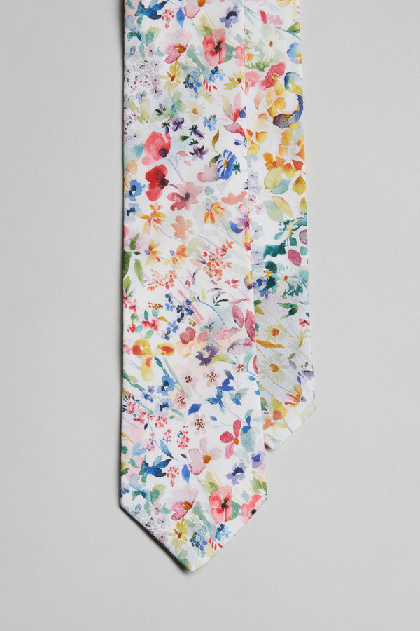 The Liberty Felda Tie by Liberty is made in New Zealand from premium Tana Lawn Cotton, showcasing a vibrant multicolored floral pattern on white with red, yellow, blue, green, and pink flowers.
