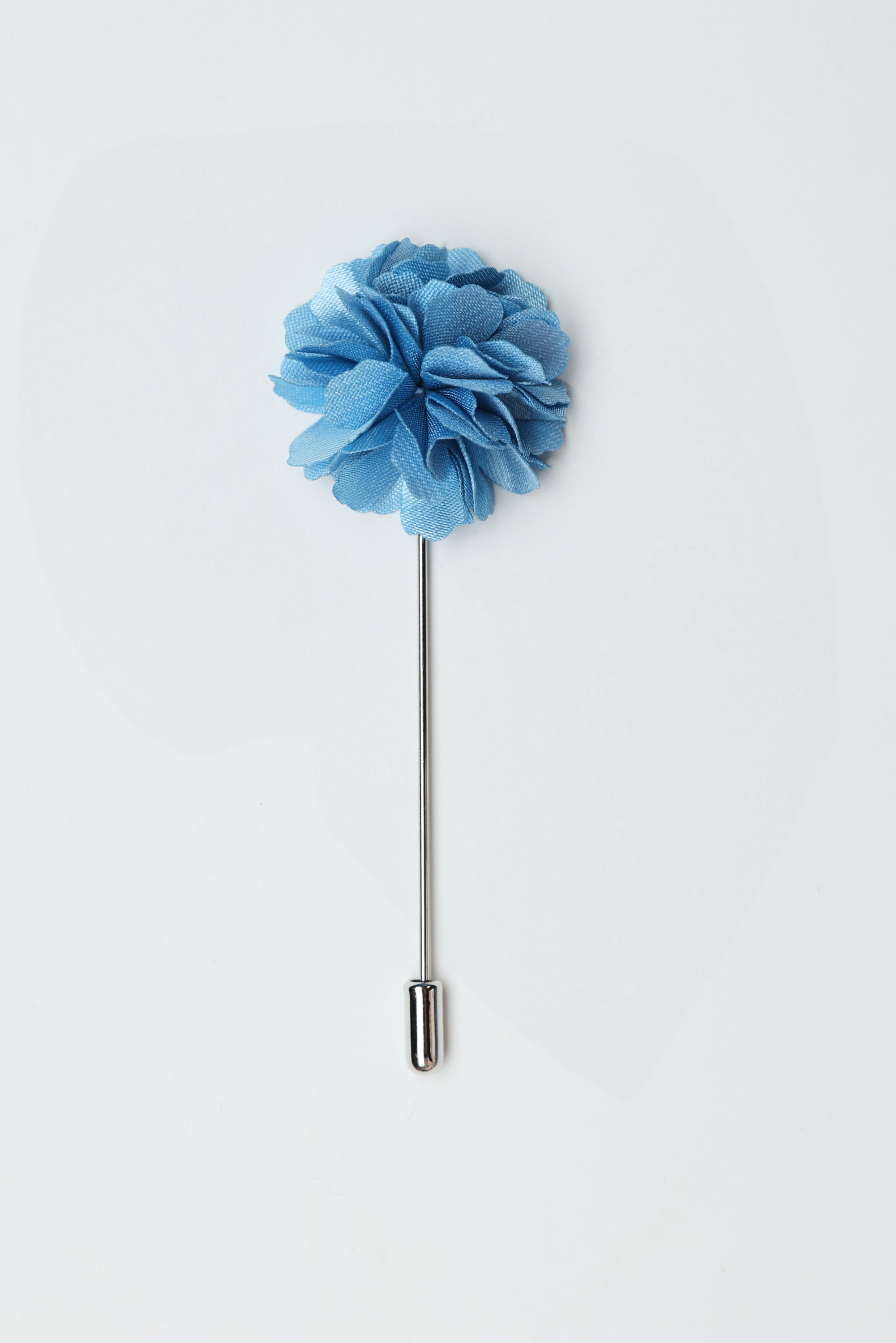 The Parisian Fraser Flower Lapel Pin features a light blue floral design with a silver stem and cap, making it an ideal suiting accessory for weddings. Displayed against a plain white background.