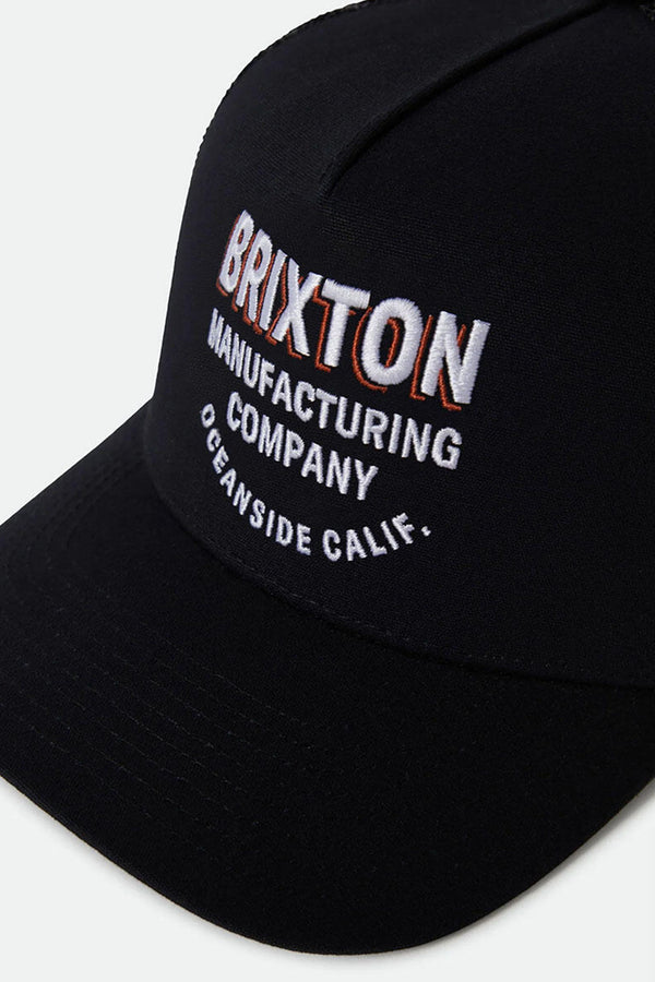 The Brixton C NP MP Trucker Hat is a black cap by Brixton with "BRIXTON MANUFACTURING COMPANY OCEANSIDE CALIF." embroidered in white and orange on the front, plus an adjustable snapback for comfort.