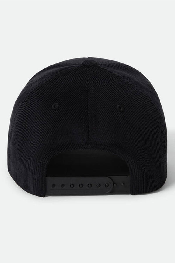 A black Brixton Pierson Snapback by Brixton is shown from the back, highlighting its cotton corduroy finish and adjustable snapback closure. The background is plain light grey.