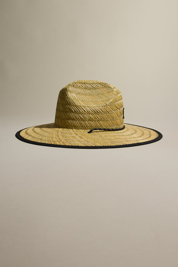 The Barkers Straw Hat by Barkers features a wide brim, black trim, and adjustable chin cord—an ideal summer essential for sun protection, shown against a neutral backdrop.