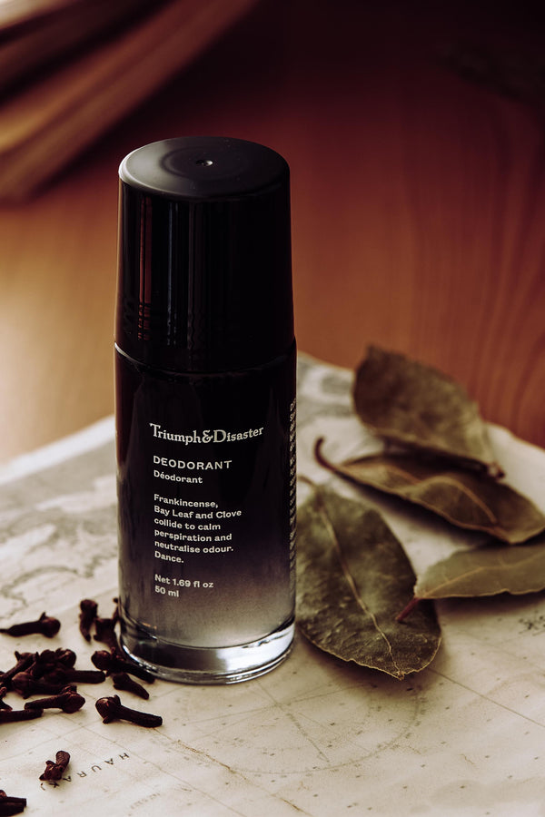 Triumph & Disaster Deodorant V1 Spice with organic ingredients sits by dried leaves and cloves.