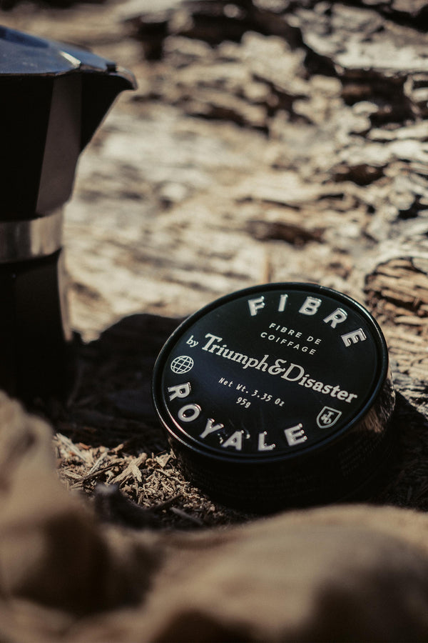 Triumph & Disaster Fibre Royale tin on wood—strong hold styling for natural hair.