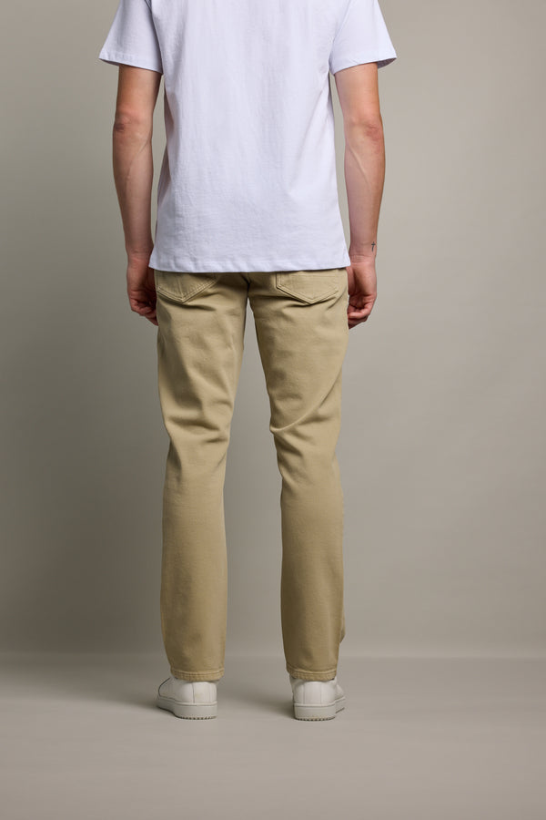 Person wearing Barkers Wanderer Straight Coloured Jean, white shirt, and white shoes, facing away.