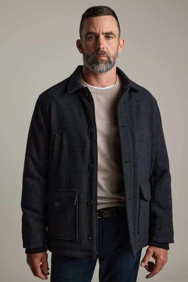 Man with a short beard in a Barkers Skyland ZQrx Merino Crew stands against a plain background.