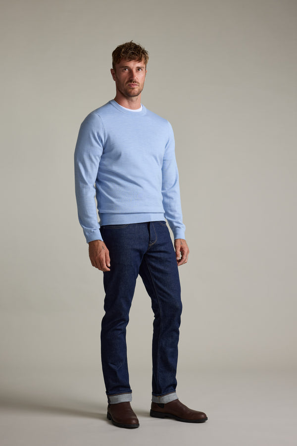 Man wears Barkers Skyland ZQrx Merino Crew sweater, dark jeans, and brown boots.