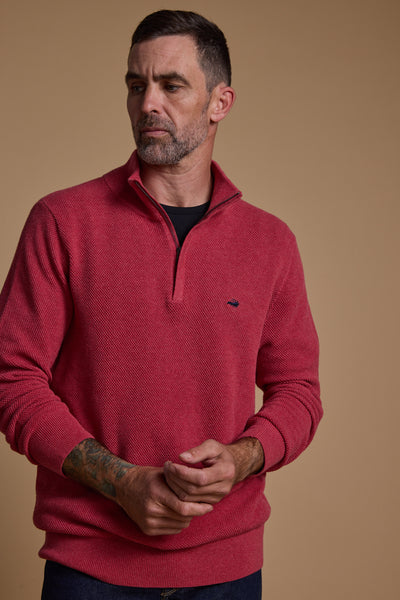 A man with short dark hair and a trimmed beard wears the Barkers Ketch Cotton 1/4 Zip sweater, standing against a plain beige background. He looks slightly to the side with his hands loosely clasped.