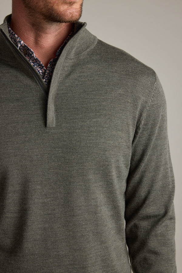 Man wearing a Barkers Skyland ZQRX Merino 1/4 Zip over a patterned dress shirt.