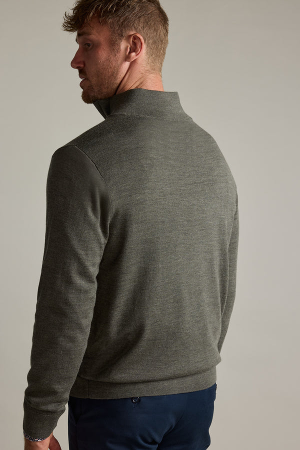 Man in Barkers Skyland ZQRX Merino 1/4 Zip, facing away, looking over his shoulder.