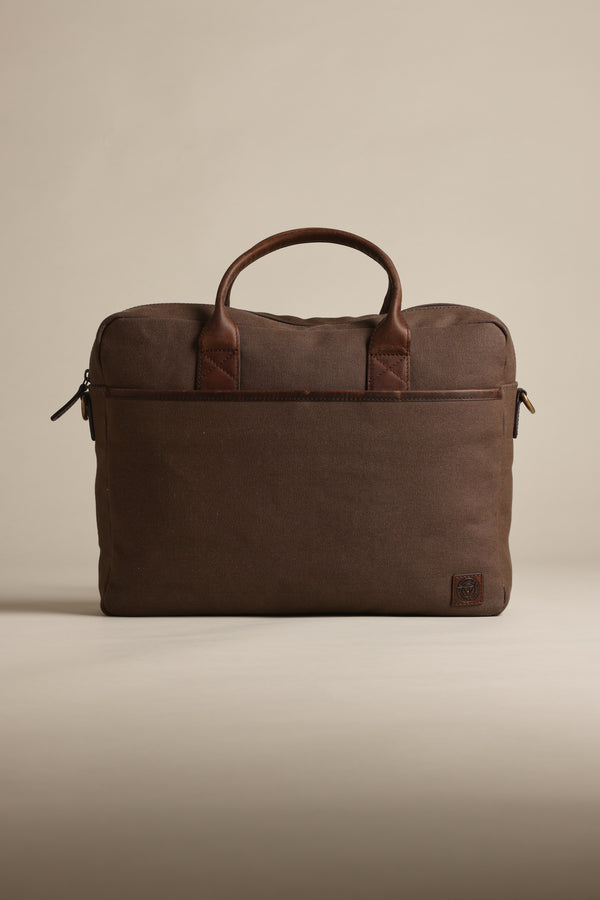 Barkers Redford canvas laptop bag with leather handles on a plain beige background.
