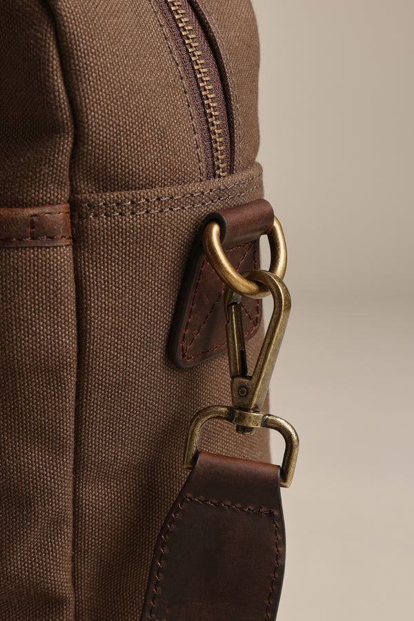 Close-up of Barkers Redford Canvas Laptop Bag with premium leather strap and brass clasp.