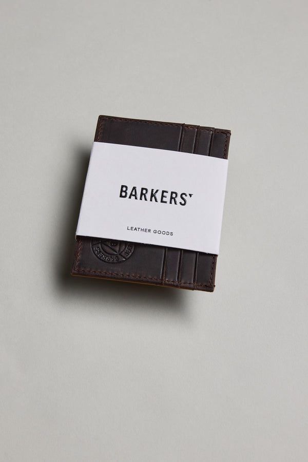 The Barkers Taylor Leather Card Wallet in dark brown sits on a light gray surface.