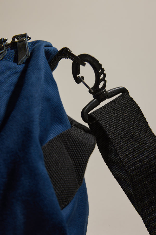 Close-up of Barkers black strap clipped to a blue Barkers Canvas Duffle Bag.