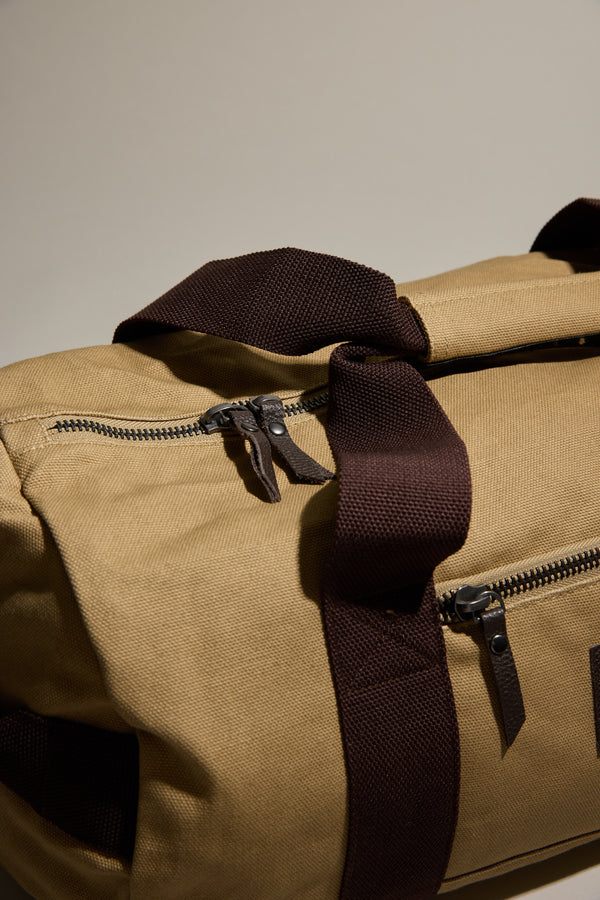 Barkers Canvas Duffle Bag: tan cotton canvas with dark brown handles; perfect for travel.