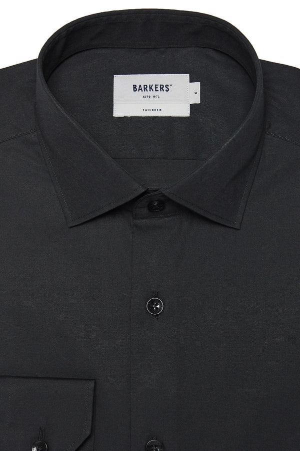 Close-up of a black Tribeca Reg Cuff Shirt by Barkers, featuring a collar and chest pocket. The shirt is neatly buttoned, pressed, and displays the Barkers label inside.