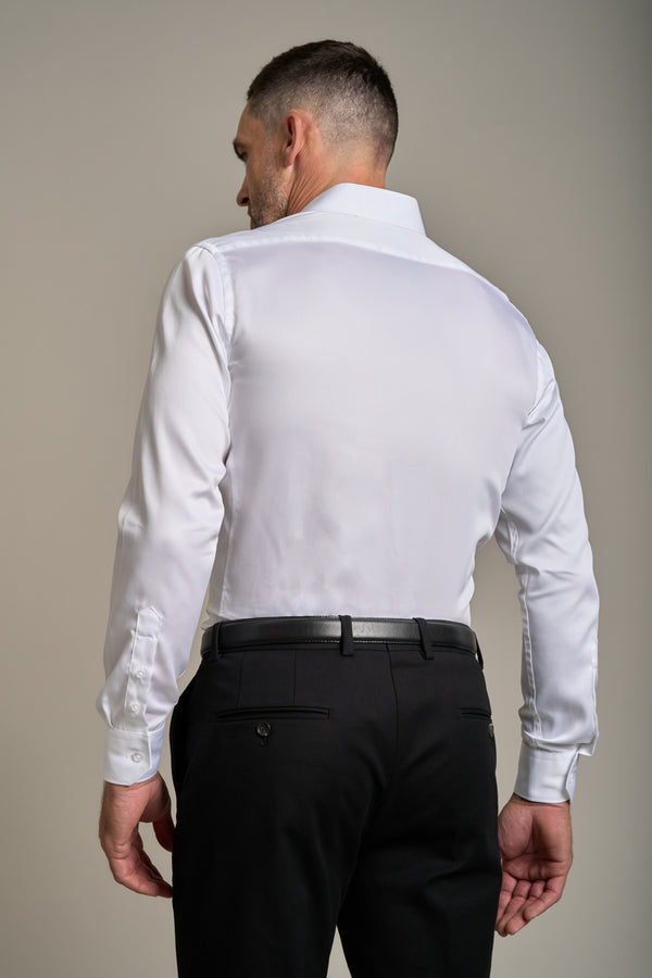 Man facing away in a Barkers Tribeca Reg Cuff Shirt and black dress pants, neutral background.