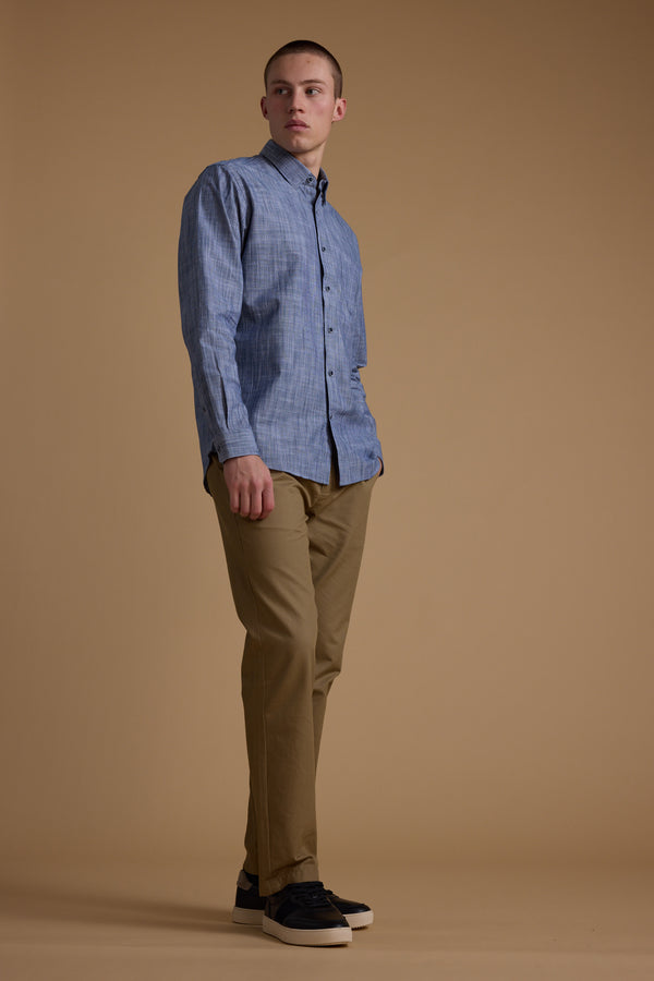 A person stands against a plain beige background wearing the Barkers Blaine Stripe Shirt, khaki pants, and dark sneakers, looking slightly upwards with a neutral expression.