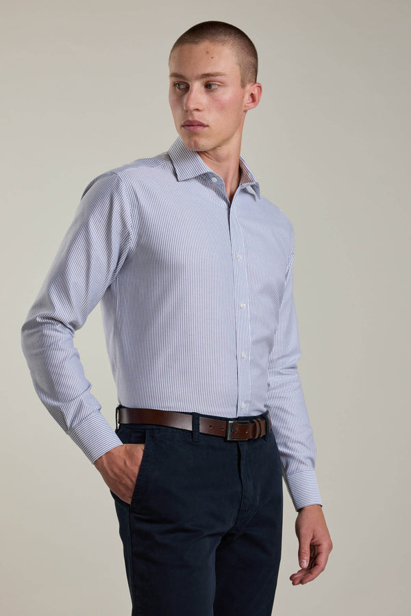 Man in Barkers Rhea Stripe shirt, tailored fit, dark pants, brown belt, hand in pocket.