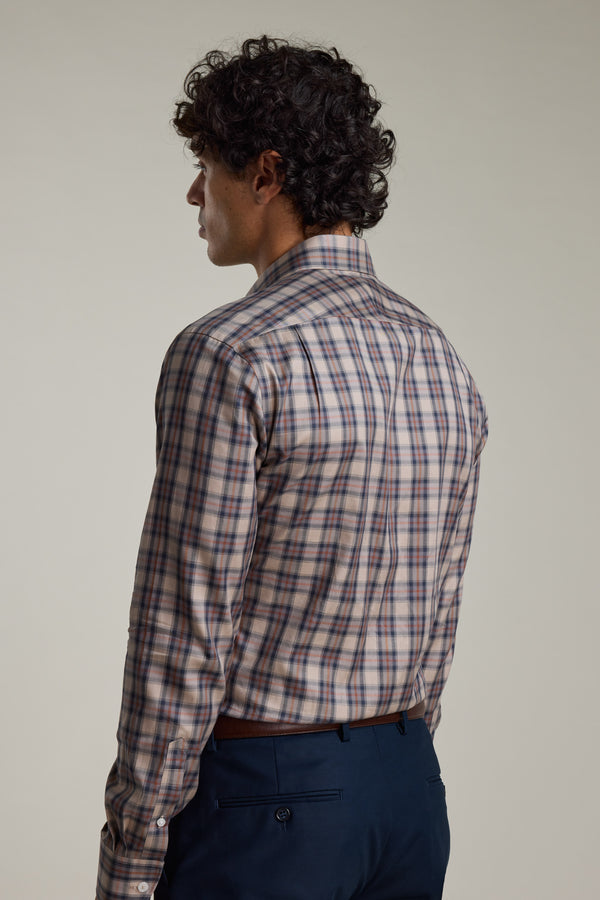 A man with curly hair, seen from behind, wears the Barkers Norco Check Business Shirt—tailored fit with long sleeves in blue, red, and white plaid—paired with dark blue pants against a plain background.
