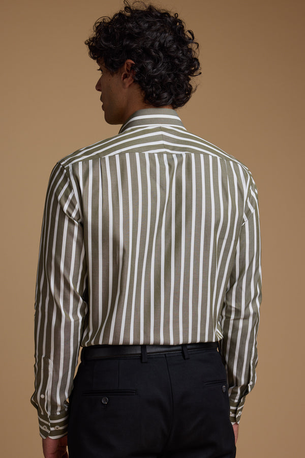 Seen from behind against a beige background, a person with curly dark hair wears the Barkers Nandas Stripe Business Shirt—an olive green and white, wrinkle-resistant, long-sleeve business shirt—tucked into black dress pants.