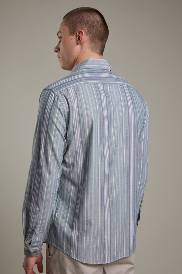 A man with short hair stands with his back to the camera, wearing the Barkers Huntley Striped Oxford Shirt and beige pants against a plain background.