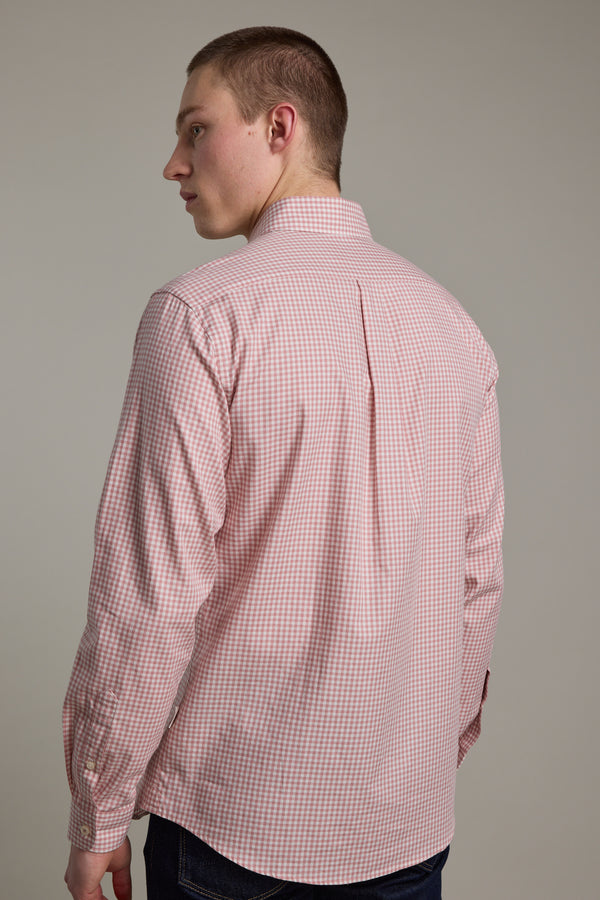 A person with short hair is seen from behind, wearing a Barkers Courtland Check Shirt with a pink and white check pattern and dark pants, standing against a plain light background.