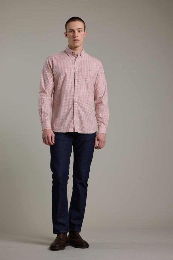 A young man stands against a plain background, wearing the Barkers Courtland Check Shirt, dark blue jeans, and brown shoes. He faces forward with a neutral expression and his arms relaxed at his sides.