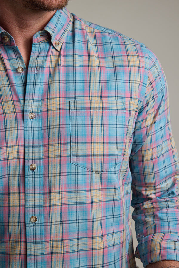 A person wearing the Barkers Hayne Check Shirt, a lightweight long sleeve cotton shirt in pastel blue, pink, yellow, and white plaid with a chest pocket and buttoned collar, shown from shoulders to waist.