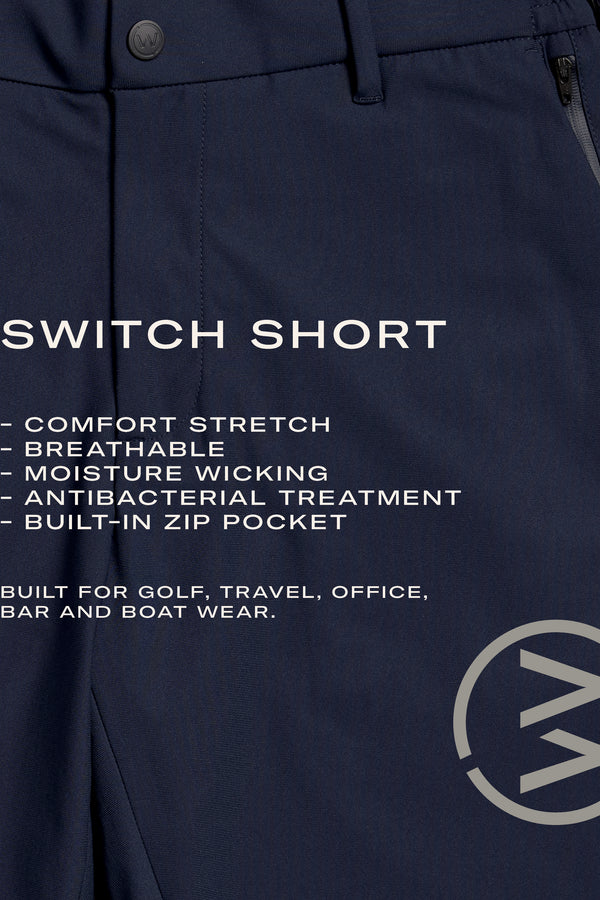 The WearEver Switch Short by WearEver is a navy blue chino-inspired short with comfort stretch, breathable, quick-dry, and moisture-wicking features, plus antibacterial treatment. It has a built-in zip pocket and circular logo on the bottom right.