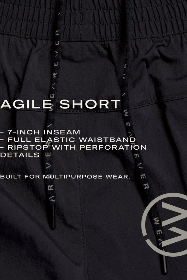 Close-up of WearEver Agile Short in black: lightweight, stretch ripstop with perforations, 7-inch inseam, full elastic waistband with drawstrings, subtle branding. Designed by WearEver for versatile, multipurpose wear.