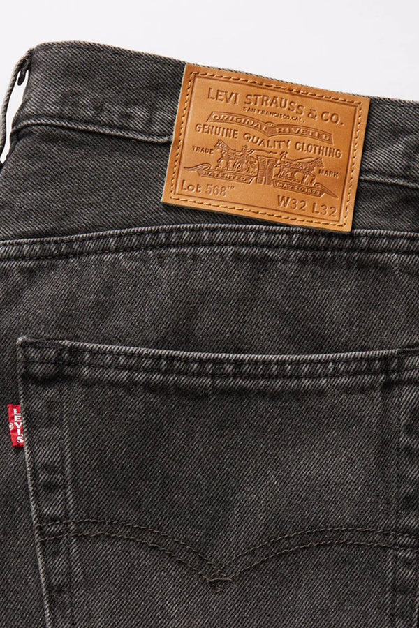 Close-up of the back of Levi's 468 Loose Short in black non-stretch denim, featuring a brown leather Levis patch above the pocket and a small red Levis tag on the pocket’s side.