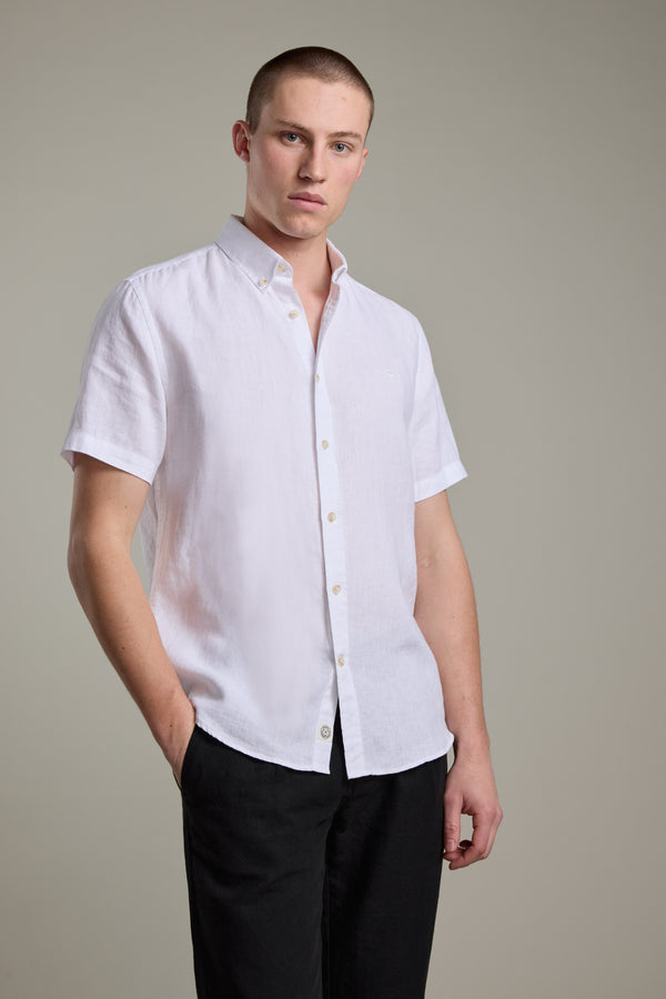 Man wearing Barkers Gentry Linen Shirt in white with black pants, standing against a plain background.