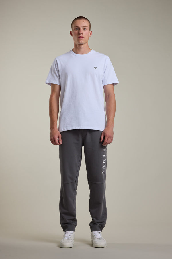 A man standing in a white shirt and Barkers Organic Classic Print Track Pant.